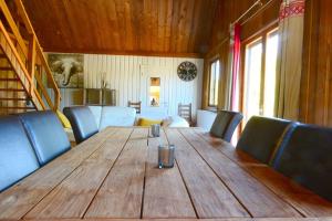 comedor con mesa de madera y sillas azules en Maison L'Hirondelle Rustique à Tournavaux en Tournavaux