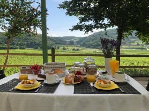 a table with breakfast food and a view of a field at B&B Ai Filari in Baone