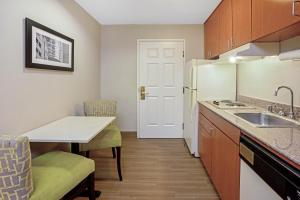 a small kitchen with a sink and a counter top at La Quinta Inn & Suites by Wyndham The Woodlands Spring in Spring