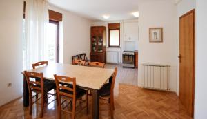 a kitchen and dining room with a table and chairs at Apartment Šverko in Kastav