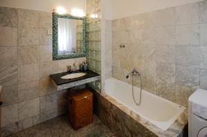 a bathroom with a sink and a bath tub and a mirror at Apartment Šverko in Kastav +6 photos