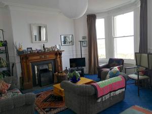 a living room with two couches and a fireplace at Period house on seafront, Bangor Co.Down in Bangor