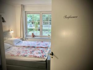 a bedroom with a bed and a window at De Bonte Specht in Nijverdal
