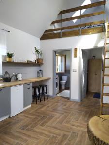a kitchen and living room with wooden flooring at #MazuryNature in Giżycko