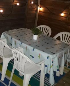 a white table with white chairs and a tablecloth on it at F2 50m de la mer avec parking privé in Valras-Plage +9 photos