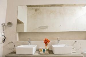 a bathroom with two sinks and a large mirror at Casa Carmen Morelos in Oaxaca City +41 photos