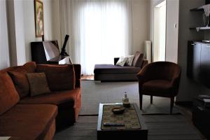 a living room with a couch and a television at Thessaloniki Waterfront apartment in Thessaloniki