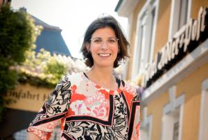 a woman is standing in front of a building at Hotel Adler Post in Schwetzingen