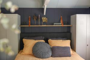 a bedroom with a bed with two pillows on it at Bed and Breakfast Het Emmapark Medemblik in Medemblik