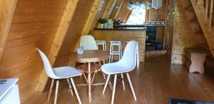 een kamer met een tafel en stoelen in een hut bij Domki letniskowe Pod Lasem in Koziniec