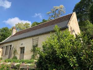 an old stone house with a black roof at Riparenna in Rivarennes