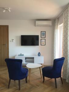 Televízia a/alebo spoločenská miestnosť v ubytovaní Apartamenty Julia APARTAMENTY OZONOWANE
