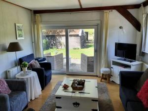 a living room with a large sliding glass door at De Eurostee - Boerderij appartementen in Schoonloo