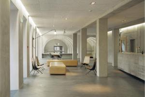 a lobby with chairs and a couch and a table at Basel Youth Hostel in Basel