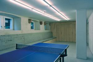 an empty room with a ping pong table in it at Basel Youth Hostel in Basel