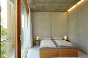 a small bedroom with a bed and two night stands at Basel Youth Hostel in Basel