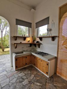 a kitchen with a sink and a stove at House Katarina in Ankaran