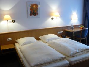 Voodi või voodid majutusasutuse Mirage City Hotel Stuttgart Zentrum toas