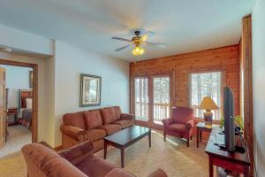a living room with a couch and a ceiling fan at Ace Condos in Pagosa Springs