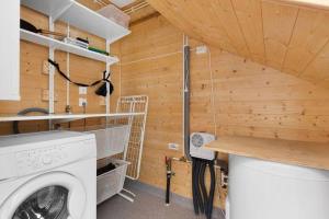 a laundry room with a washer and dryer at Seaside Holiday Home, great for fishing & hiking in Hellesøyni