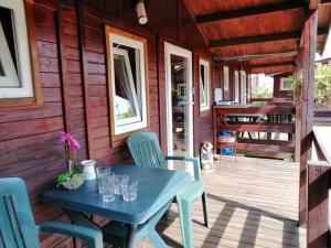 a table and chairs on the porch of a cabin at Domki Letniskowe Ster in Międzyzdroje