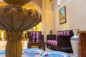 a living room with a couch and a table at Riad Mimouna in Essaouira