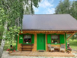 a small yellow and green house with a table and chairs at GREEN HOUSE in Krasnopol