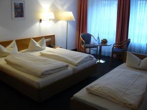 Voodi või voodid majutusasutuse Mirage City Hotel Stuttgart Zentrum toas