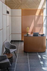 a waiting room with a desk and two chairs at Indie Hotel Kuala Lumpur in Kuala Lumpur