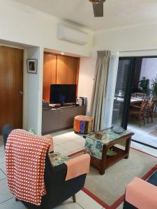 a living room with a couch and a table at Jackies City Central Apartment in Cairns