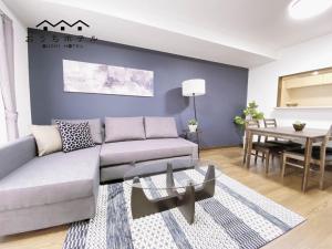 a living room with a couch and a table at OUCHI HOTEL Itsukaichi in Hiroshima