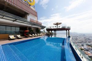 a swimming pool on top of a building with a city at Regalia Gold Hotel in Nha Trang