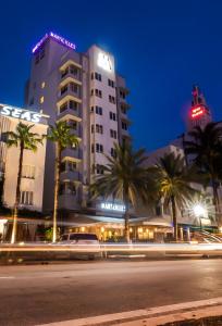 a large building with a clock on the side of it at Marseilles Beachfront Hotel in Miami Beach