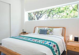 A bed or beds in a room at K Gallery Hotel