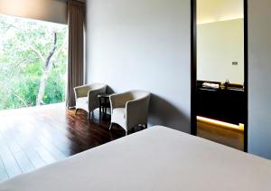 A bed or beds in a room at K Gallery Hotel