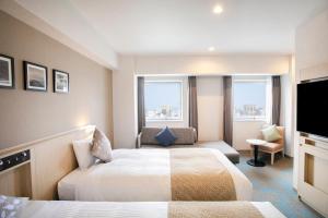 大分ART Hotel Oita的有两张床和一台电视的酒店房间