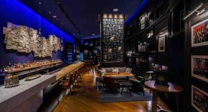 a bar at a restaurant with tables and chairs at Andaz Xintiandi Shanghai-Free Minibar & Lounge Happy Hour in Shanghai