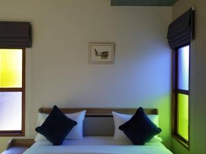 Postel nebo postele na pokoji v ubytování บ้านน่านอน