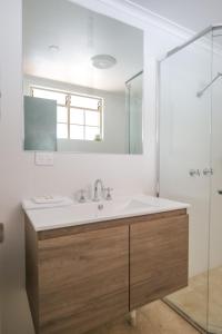 a bathroom with a sink and a shower at Bayview Hotel Woy Woy in Woy Woy