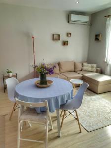 a living room with a table and chairs and a couch at Into The BLUE, 4 guests, 5 min away from the BEACH in Varna City