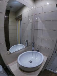 a bathroom with a sink and a mirror at Into The BLUE, 4 guests, 5 min away from the BEACH in Varna City