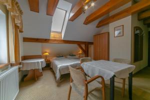 a bedroom with a bed and a table and chairs at Willa SUDETY in Karpacz