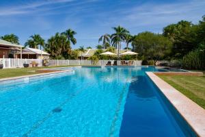 a large swimming pool with blue water at The Kimberley Grande Resort in Kununurra