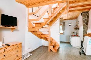a wooden staircase in a tiny house at Widokówka in Pokrzydowo