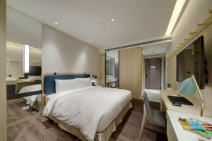 Ένα ή περισσότερα κρεβάτια σε δωμάτιο στο Jasper Young Hotel Banqiao