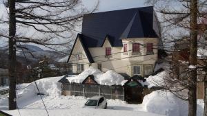 a large house is covered in snow at Annex Aburaya in Iiyama
