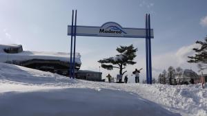 a sign for a ski resort in the snow at Annex Aburaya in Iiyama