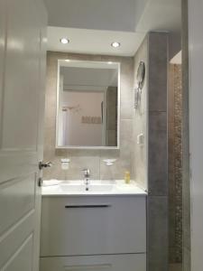 a bathroom with a sink and a mirror at Ambelas Mare Apartments in Ambelas