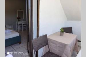 a room with a table and a bed and a table and chair at Iason studio 2 in Patitiri