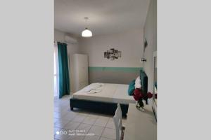 a bedroom with a bed and a table and chairs at Iason studio 2 in Patitiri +9 photos